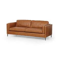 Clean, mid-century styling plus rich butterscotch top-grain leather equals our Livie Sofa. With her tailored lines and slim legs of antique brass she adds laid back luxe vibes to your space.Overall Dimensions: 84.00"w x 36.00"d x 31.50"hColor: rich butterscotchMaterials: Top grain leather.FREE SHIPPINGPLEASE NOTE THIS IS FROM OUR DESIGNER LUXE COLLECTION. PLEASE ALLOW 4-6 WEEKS FOR DELIVERY Plush Sofa, Lulu And Georgia, Leather Couch, Brown Sofa, Simplistic Design, Burke Decor, Mid Century Style, Top Grain Leather, Room Sofa