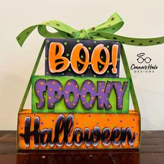 a wooden block that says boo spooky halloween