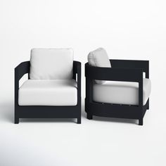 two black and white chairs sitting next to each other on a white surface with one chair facing the other