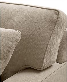 a close up view of the back of a couch with two pillows on top of it