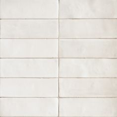 a white tiled wall with several lines on it