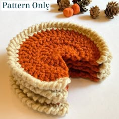 three crocheted dishcloths sitting on top of each other with pine cones in the background