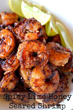 spicy lime honey seasoned shrimp served with lemon wedges