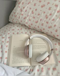 an open book with headphones on top of it