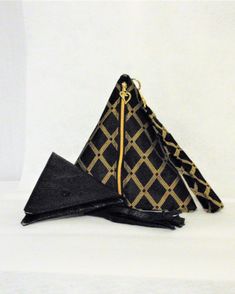 Unique Pyramid Triangle purse, Handmade purse comes with 5-inch Triangle coin purse I am including the coin purse that is designed to store your necessary small items The coin purse is spacious 5 inches X 5 inches: fits items such as: Credit Cards coins, Lipstick, Lip gloss Cash, Mask, Ear buds Business cards Tissues This Pyramid Triangle purse is Handmade by me in a smoke FREE Home Studio Measurements 8.5 inches x 8.5 inches Matching wristlet strap is 7 inches Gold Black metallic zipper Tassel Chic Black Bifold Coin Purse, Modern Black Bifold Coin Purse, Pyramid Purse, Black And Gold Purse, Triangle Purse, Black Square Bag With Gold-tone Hardware, Handmade Purse, Purse Handmade, Ear Buds