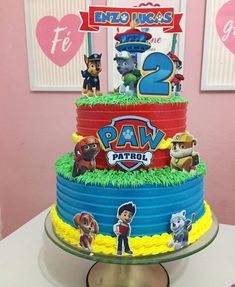 a birthday cake with paw patrol characters on it's tiers and the number two