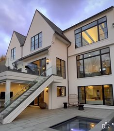 a large white house with stairs leading up to it