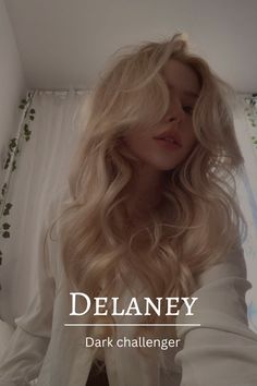 a woman with long blonde hair is posing in front of a window and the words delaney on it