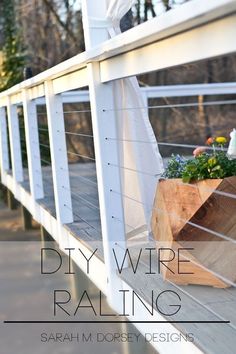 a wooden planter sitting on the side of a white porch with text overlay