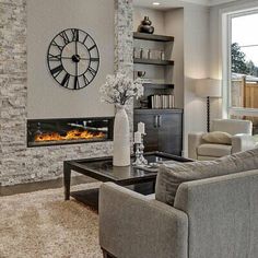 a living room filled with furniture and a large clock mounted to the side of a wall