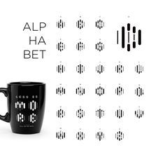 a black coffee mug sitting on top of a table next to an array of numbers