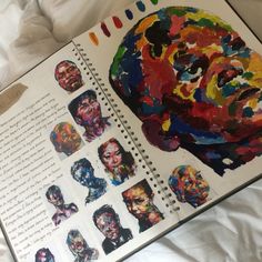 an open book with pictures of people's faces on it and the pages are covered in multicolored paper