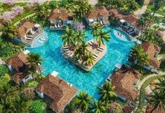 an aerial view of a resort surrounded by palm trees and other tropical vegetation, with swimming pools in the middle