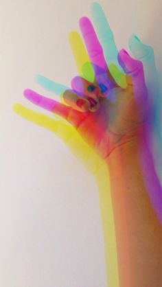 a person's hand with multicolored paint on it