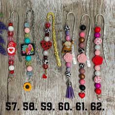 a number of different types of earrings on a wooden surface with the price tag for each pair