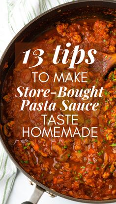 a skillet filled with pasta sauce on top of a table