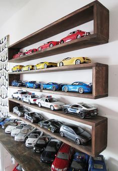 there are many toy cars on the shelves