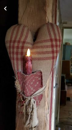 a heart shaped candle hanging from the side of a door with burlocks on it