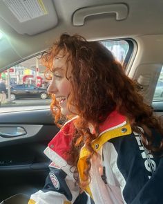 a woman sitting in the passenger seat of a car