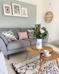 a living room filled with furniture and flowers on top of a coffee table in front of a gray couch