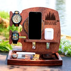 a wooden docking station with an iphone, watch and other items