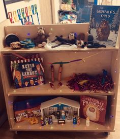 a book shelf filled with lots of books and other items on top of wooden shelves