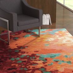 a chair sitting on top of a colorful rug