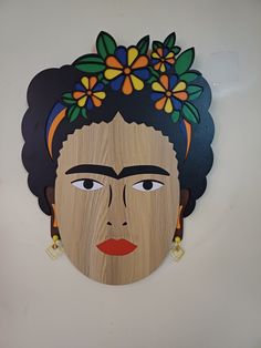 an image of a woman's face with flowers in her hair on the wall