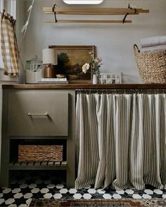 a bathroom with a sink, shower curtain and shelf above the bathtub in front of a window