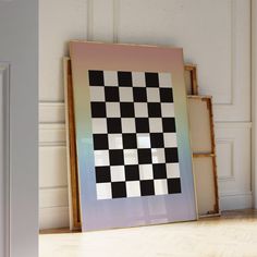 a black and white checkerboard pattern is displayed in an empty room