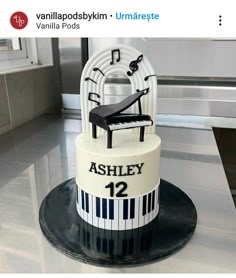 a cake that is sitting on top of a table with music notes and piano keys