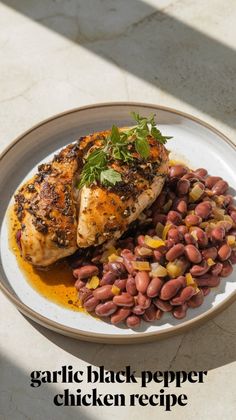 a white plate topped with meat and beans