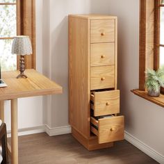 a wooden desk with two drawers and a laptop on top of it in front of a window