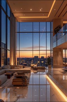 a living room filled with lots of furniture and large windows overlooking the city at night