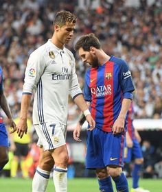 two soccer players are standing next to each other