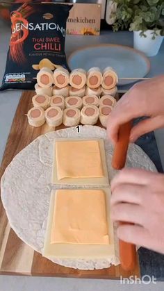 a person cutting up food on top of a table