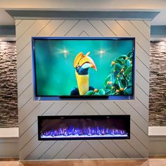 a large flat screen tv mounted to the side of a wall next to a fire place