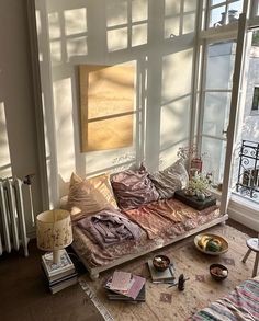 a living room filled with furniture and lots of windows next to a radiator