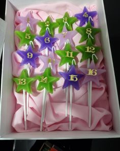 a box filled with purple and green stars