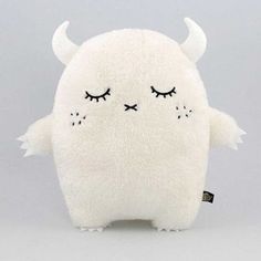 a white stuffed animal with horns and eyes