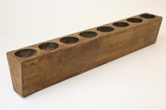 a wooden block with six holes in it