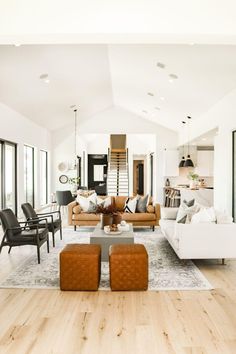 a living room filled with furniture and lots of windows