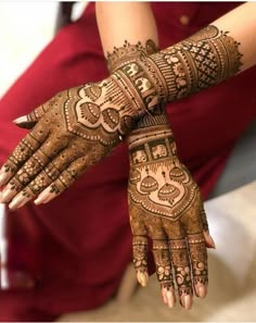 a woman's hands with hennap on it and her hand painted in intricate designs