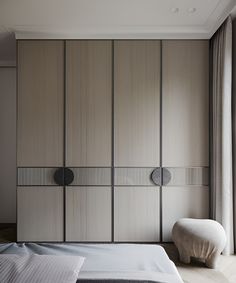 a bed sitting next to a tall wooden wall with sliding doors on it's sides