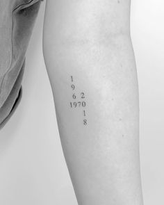 a woman's leg with numbers on it and the word date tattooed in black ink