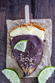 a piece of cake with chocolate and limes on it