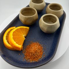 there are four orange slices and spices on the plate