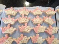 there are many pink and white stars on the cookie sheet