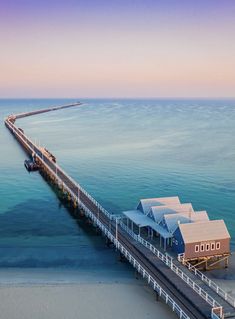 an aerial view of a pier with houses on it