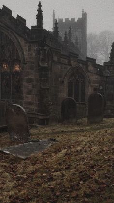 an old cemetery with tombstones in the foreground and a gothic church in the background